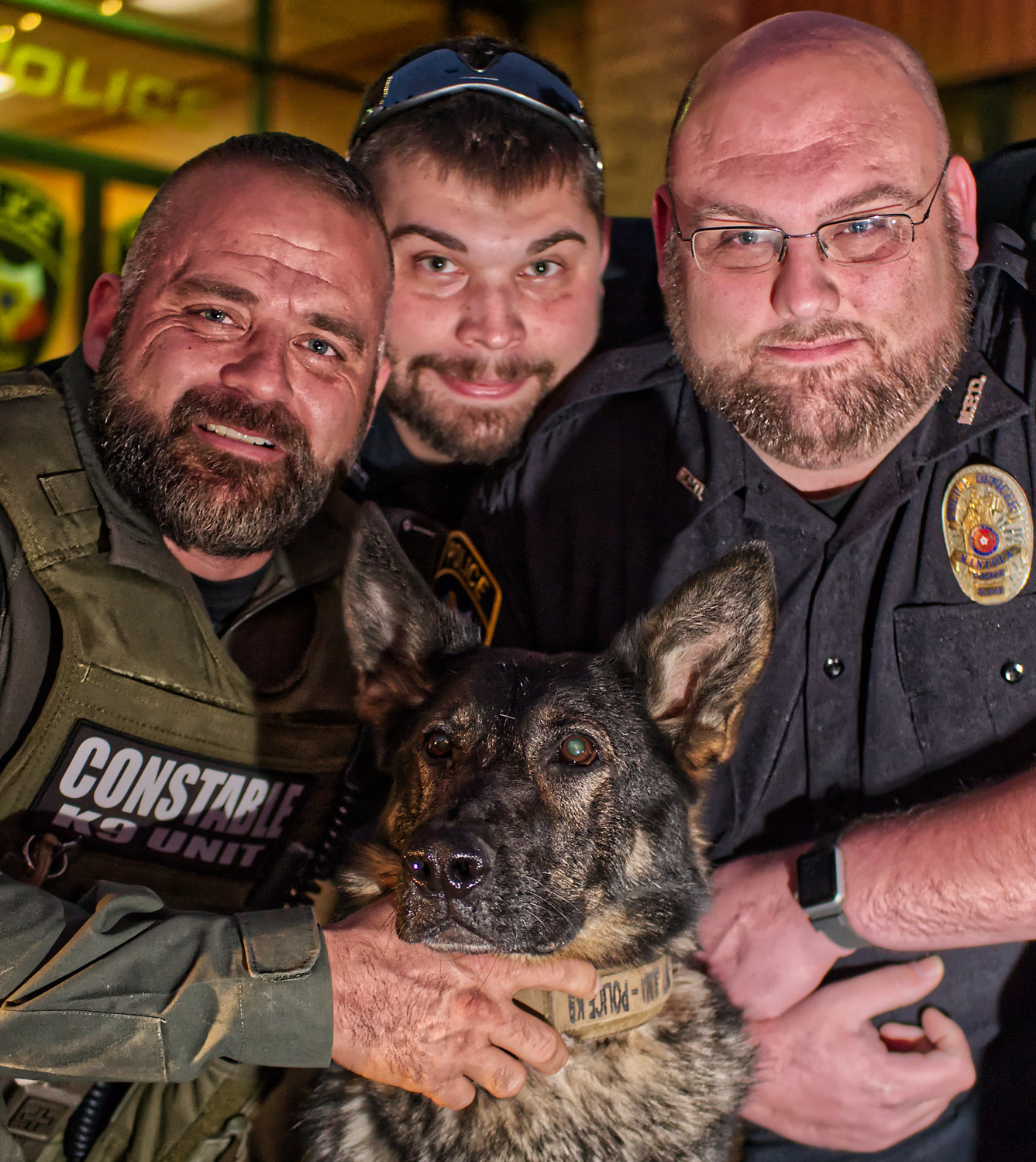 What started as stubble turned to shaggy and was trimmed to sharp, but no mane could compete with K-9 Juma's black and copper coat, pictured here (left to right) with Constable Kelly Smith, Officer Tucker George and Investigator Tommy Carden.